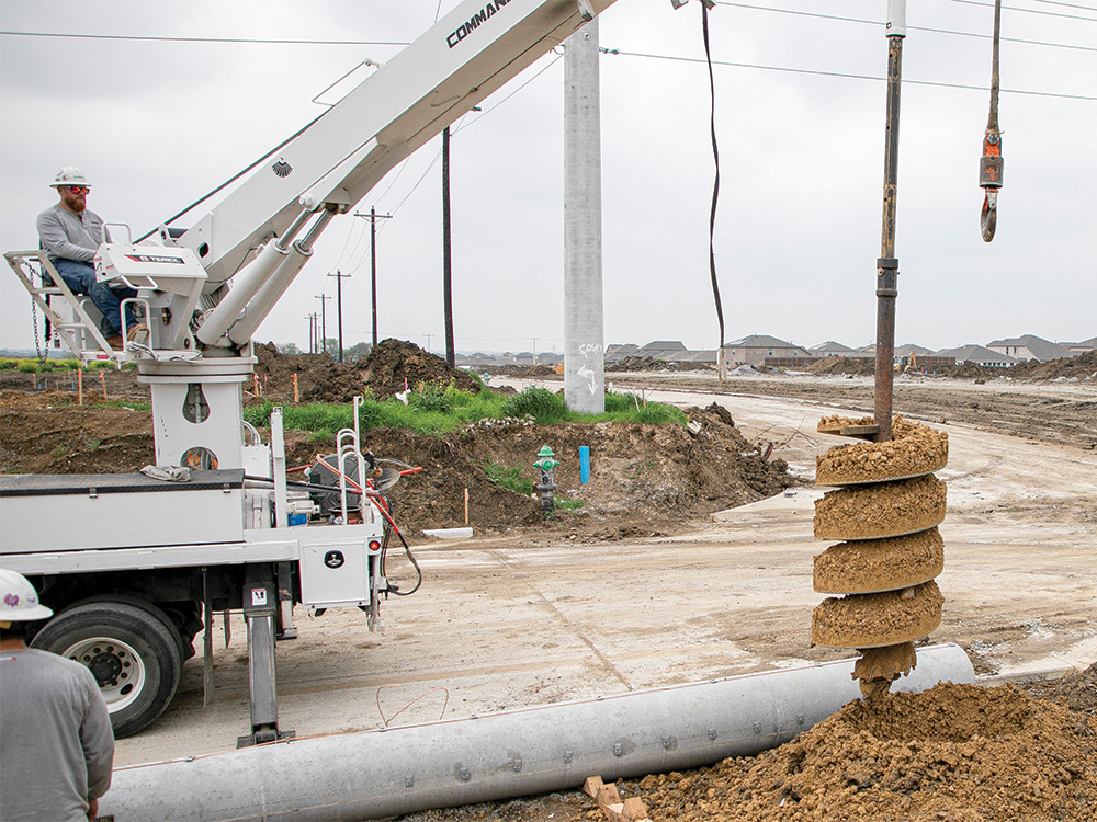 CoServ Journeyman Jacob Barreiro 
digs the hole for the concrete pole.