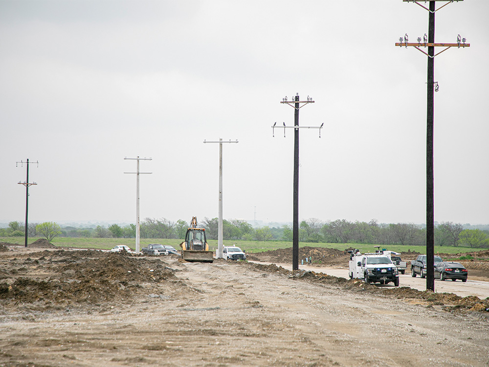 Linemen installing concrete poles in the far eastern Pilot Point area. Moberly Farms Neighborhood.