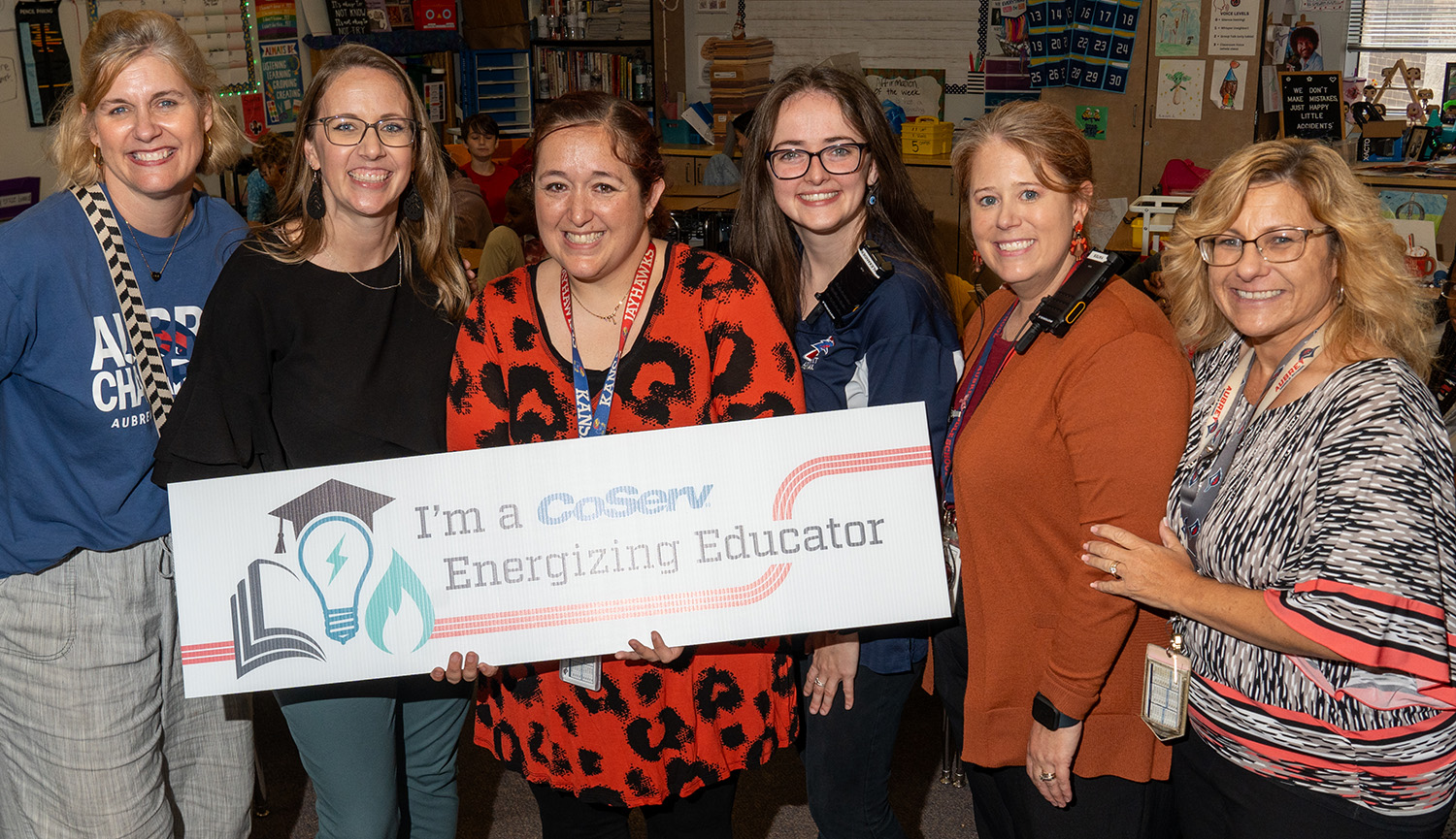 CoServ Academic Initiative team awards Aubrey Middle School teacher Shenna LeMay-Nelssen with one of CoServ's Energizing Educator Award in Aubrey. Pictured (L to R) Lisa Griffin - Counselor, Dr. Heather Baker - Principal, Sheena LeMay-Nelssen - Teacher, Jessica Alexander - 6th Grade Asst. Principal, Carrie Yates - 7th Grade Asst. Principal, Brandee Gallagher - Teacher Facilitator.