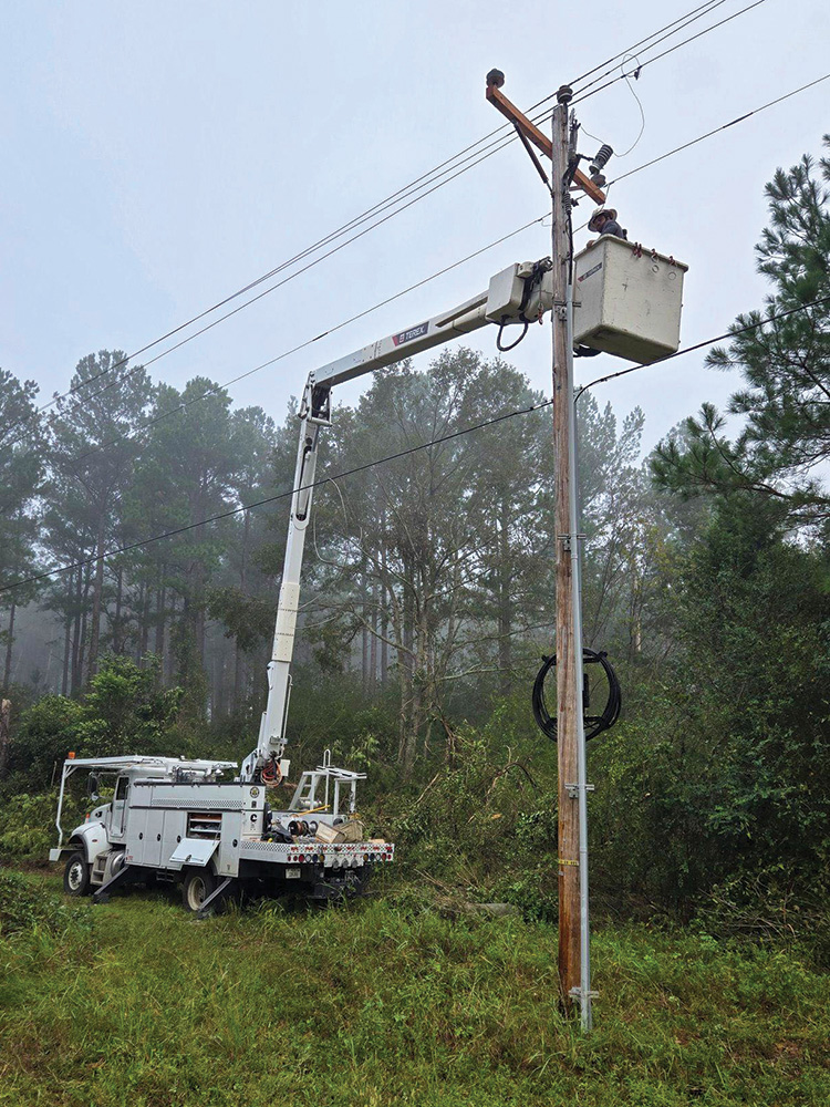 CoServ crews spent many days rebuilding poles and wires. Photo courtesy of CoServ Lineman crew