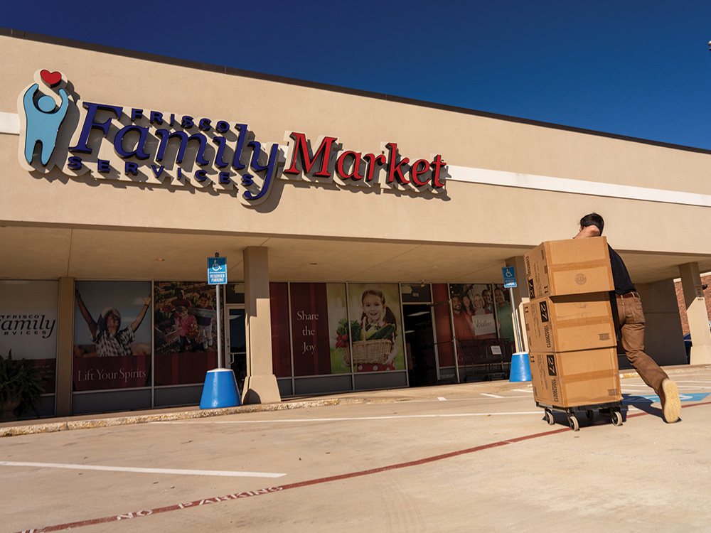 Walker Sims hauls in boxes of heaters and blankets to Frisco Family Services.