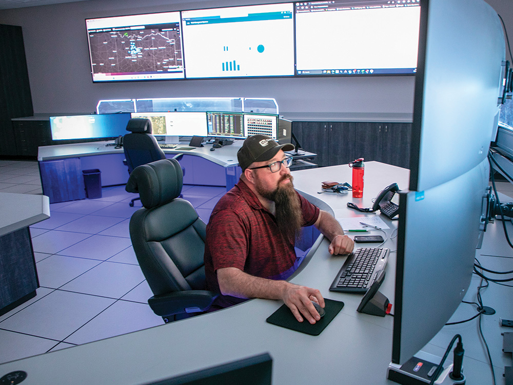 Senior Distribution System Operator Robert Sprabeary monitors the western half of the CoServ service area at the Krum Service Center. Photo by KEN OLTMANN