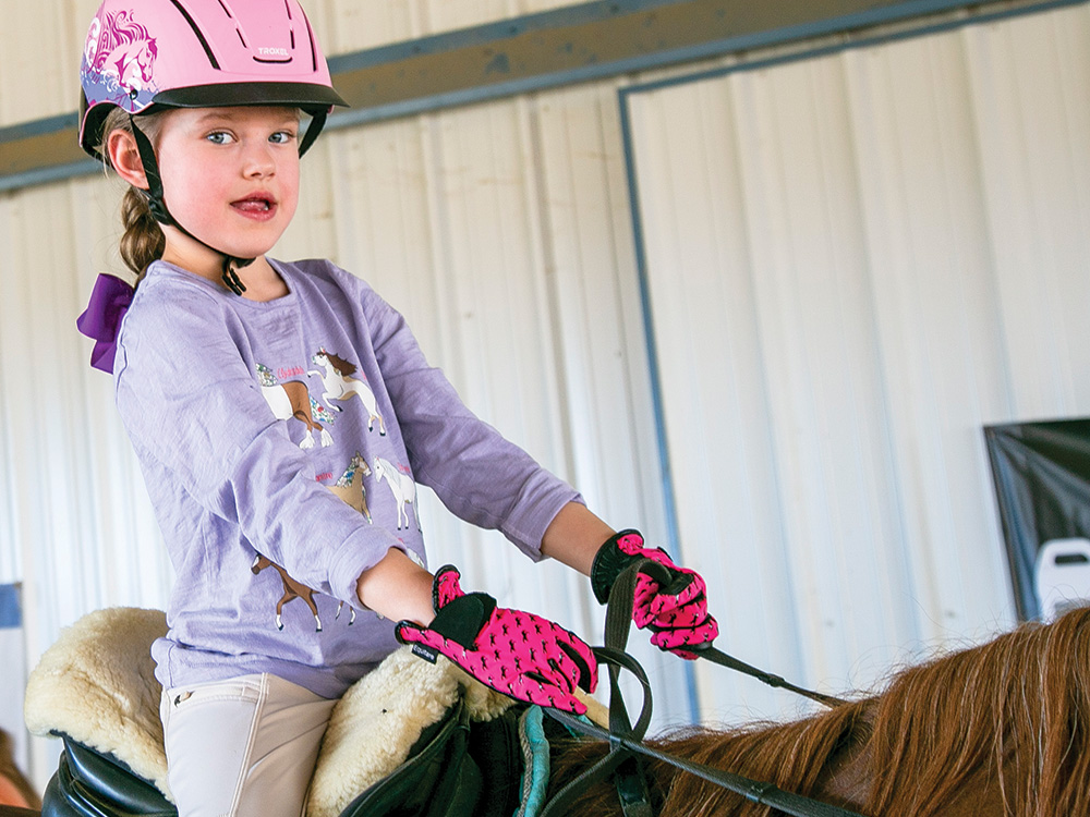 Blake Blanchard takes the reigns of a horse at EquiHope.