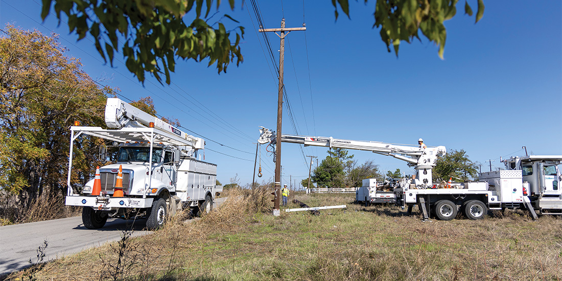 CoServ linemen upgraded the line and installed new utility poles to accommodate new growth in Justin. Photos by KEN OLTMANN