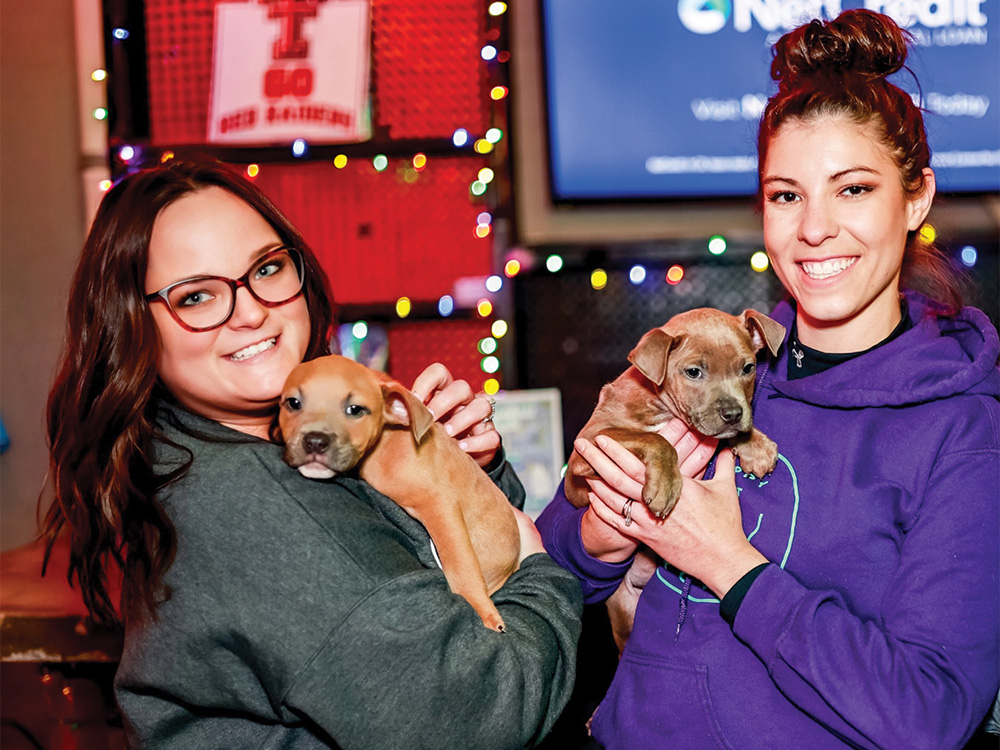 Ashtin Pizarro (left) with a puppy at the Happy Pet’s Giveback Happy Hour event at High Fives in Dallas. Photo submitted by ASHTIN PIZARRO