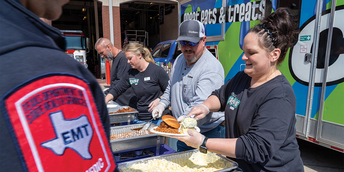 Ashtin Pizarro and other CoServ Employees use the Snackin' Wagon to feed first responders. Photo by BRIAN ELLEDGE