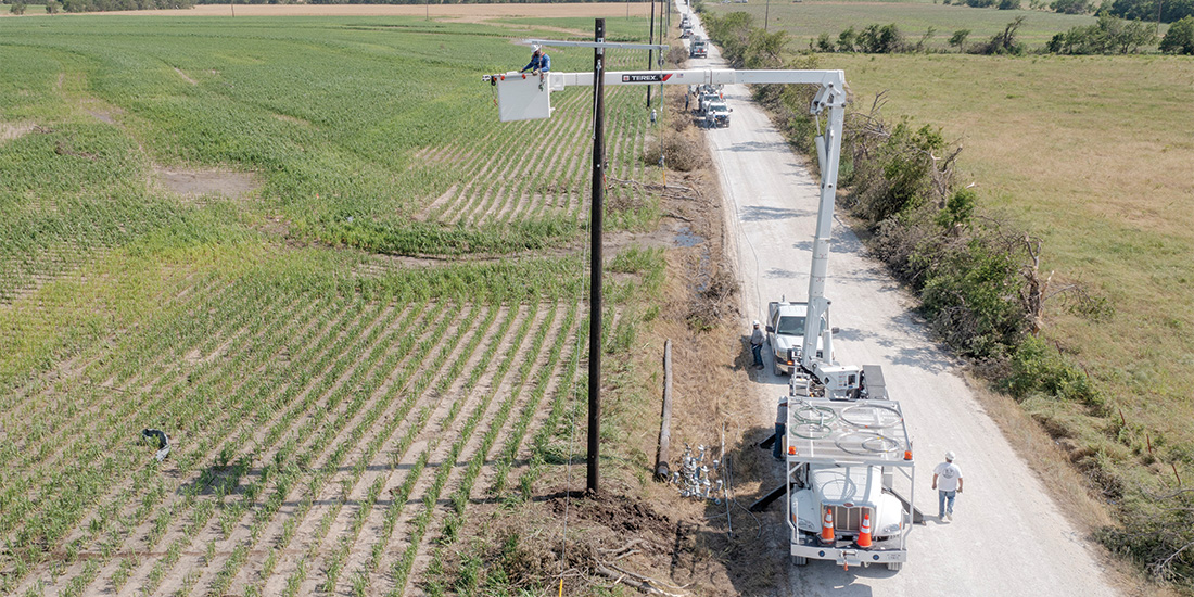 CoServ linemen had to replace most
of the infrastructure in the area, which was destroyed by the storms. Photo by KEN OLTMANN