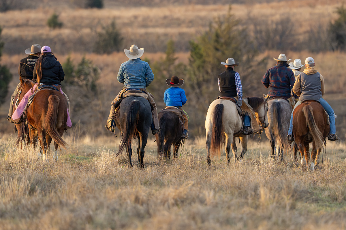 The Schumachers lead family and friends into the pasture for the yearly roundup, gathering cattle and calves the old‑fashioned way. Photo by BRIAN ELLEDGE | CoServ