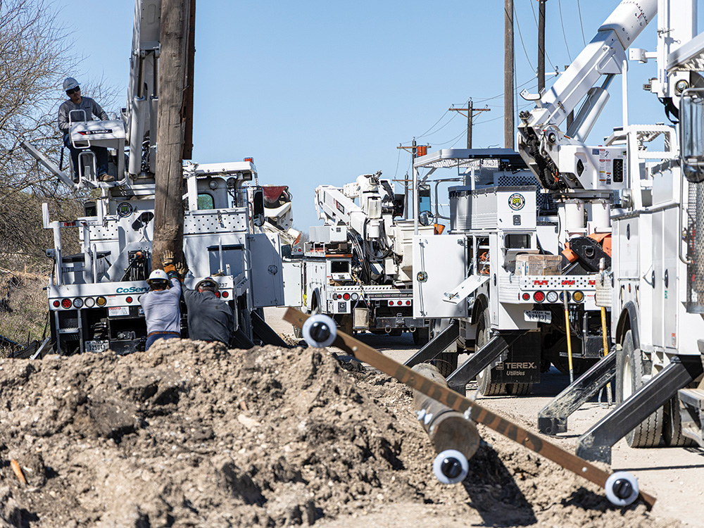 Linemen setting a new pole in Frisco, along the future extension of Panther Creek Parkway.